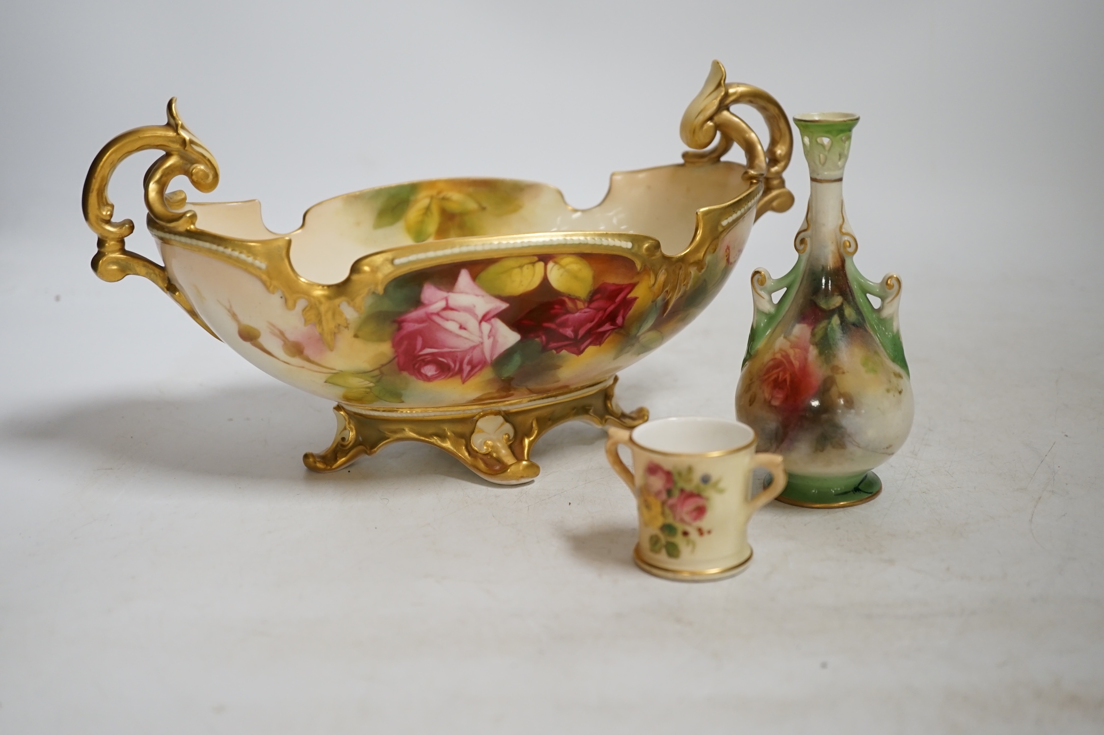 A Royal Worcester floral painted, twin handled dish, painted by Ethel Spilsbury, together with a miniature Worcester blush mug and a Hadley Worcester vase, dish 23.5cm wide. Condition - poor-fair